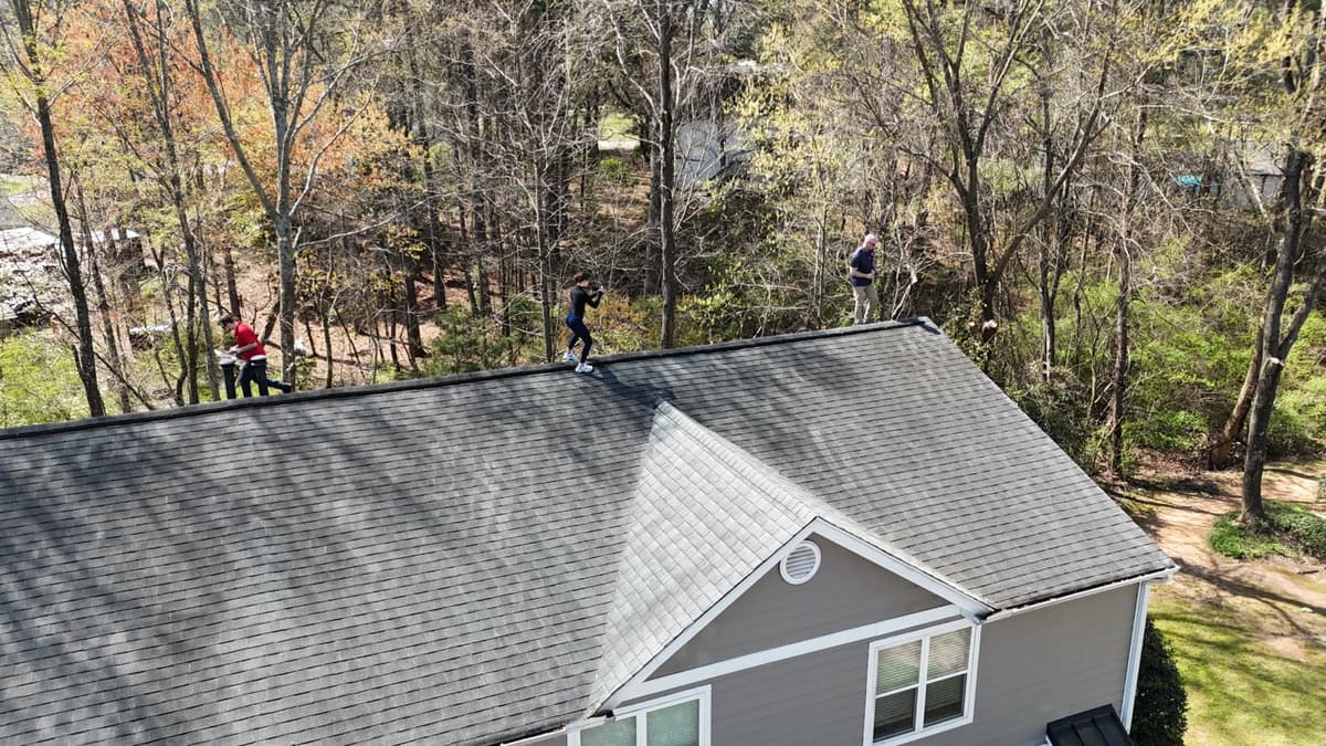 Capital City Roofing crew on a roof ridge during a Roofs for Heroes installation